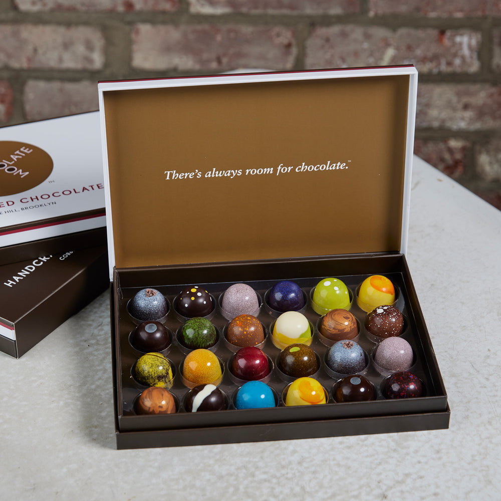 An open 24 piece of colorful chocolate handcrafted bonbons