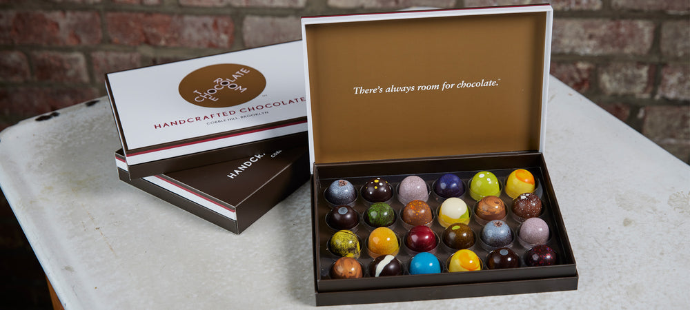 An open 24 piece of colorful chocolate handcrafted bonbons