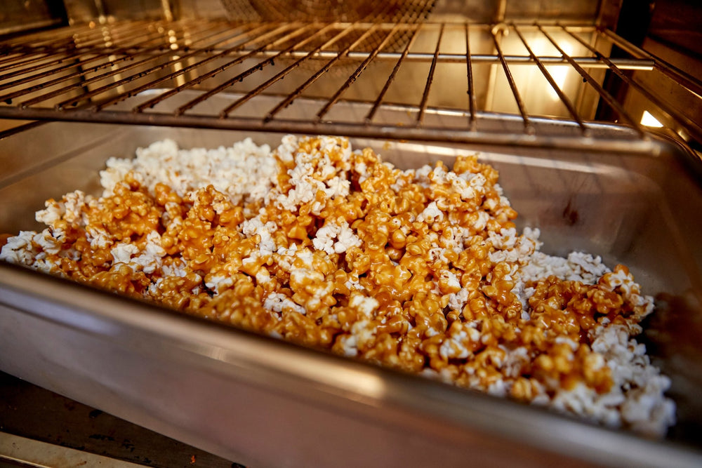 
                  
                    Inside oven view on a pan full of popcorn and melted caramel sauce
                  
                