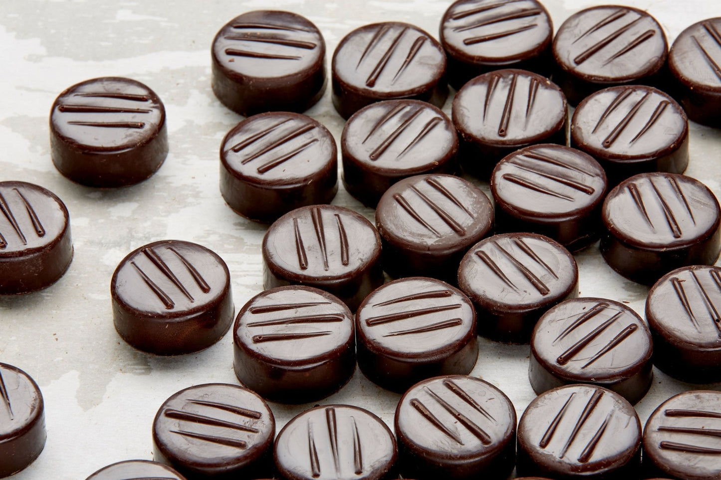 Close up of a sheet tray full of just made peppermint patties